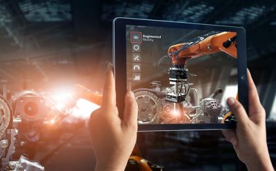 person operating robotic arm via tablet, manufacturing | DXC Technology customer story