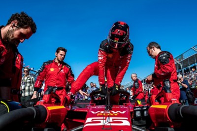 f1 driver climbing into car