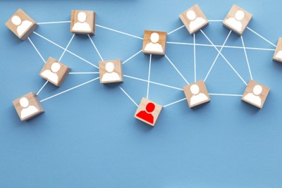 Wooden blocks connected together on a blue background. Teamwork concept