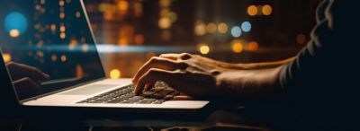 Businessman working on laptop computer after company chose VMware cloud solution strategy | DXC Technology