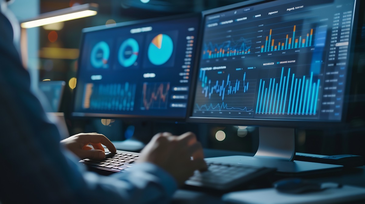 Businessman analyze data representing Intelligent Operations, Hogan Core Banking Platform | DXC Technology Platforms