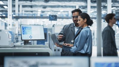 Two industrial engineers reviewing product design, supply chain management solution | DXC Technology 