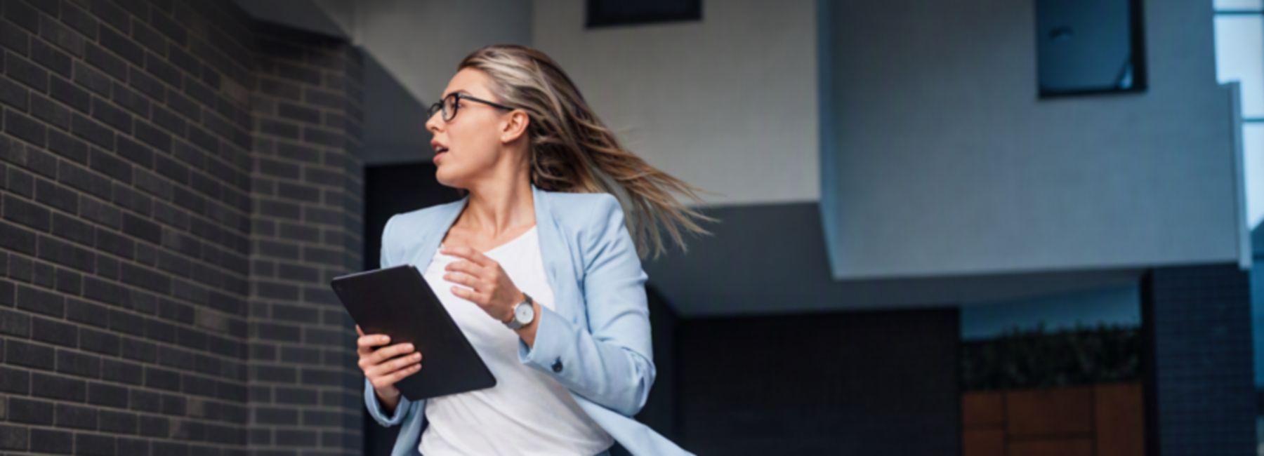 woman sprinting with a tablet | DXC Technology