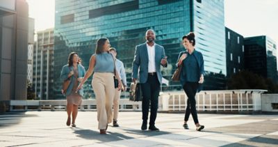  group of happy office workers heading to work, representing users satisfied with Windows 11 upgrade | DXC Technology