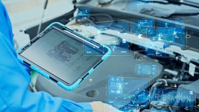 Automotive mechanic inspecting the engine compartment of a car and digital data concept | DXC Technology