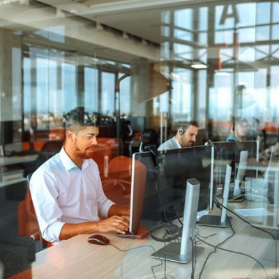 Employees working with computers representing Life & Annuity | DXC