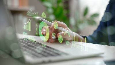 Hand analyzing environmental data with net zero dashboard, Business Process Services, Financial Services | DXC Technology
