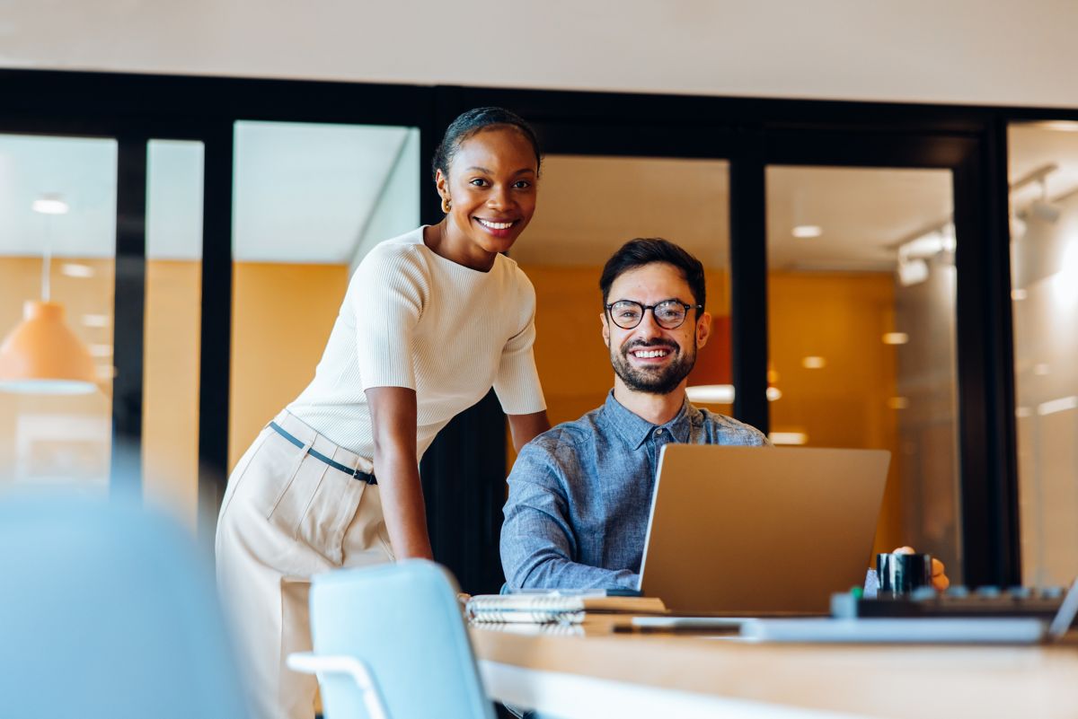 smiling colleagues working together, ServiceNow and agentic AI | DXC Technology Insights