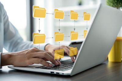  image of folders floating atop a PC, with arrows pointing to other folders, representing Windows 11 transition | DXC Technology