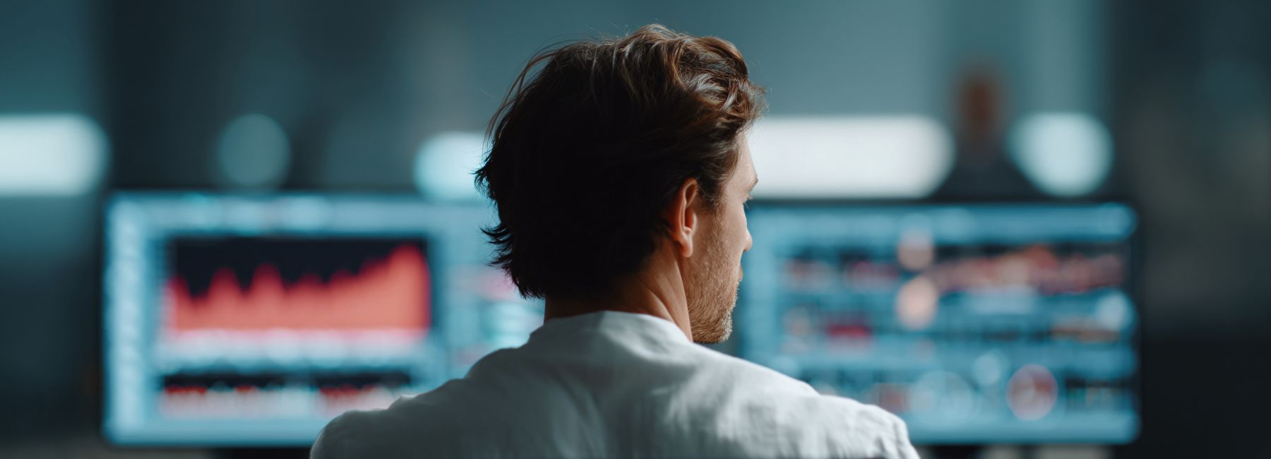 Professional analyzing complex data on monitors representing fast BDC with SAP | DXC Technology