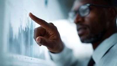 Person analyzing data representing Growth Acceleration, Corporate Strategy Advisory Services | DXC Technology