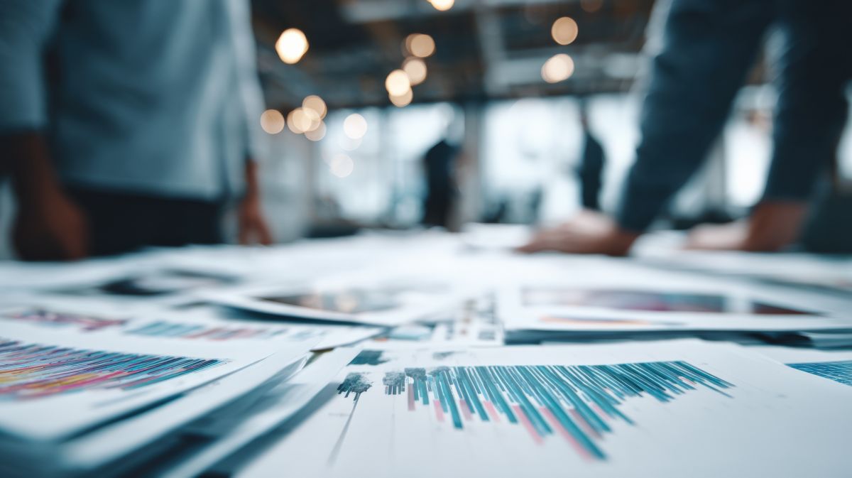 Documents with the financial graphs and numbers representing Trading Systems as-a-Service for Financial Services | DXC Technology
