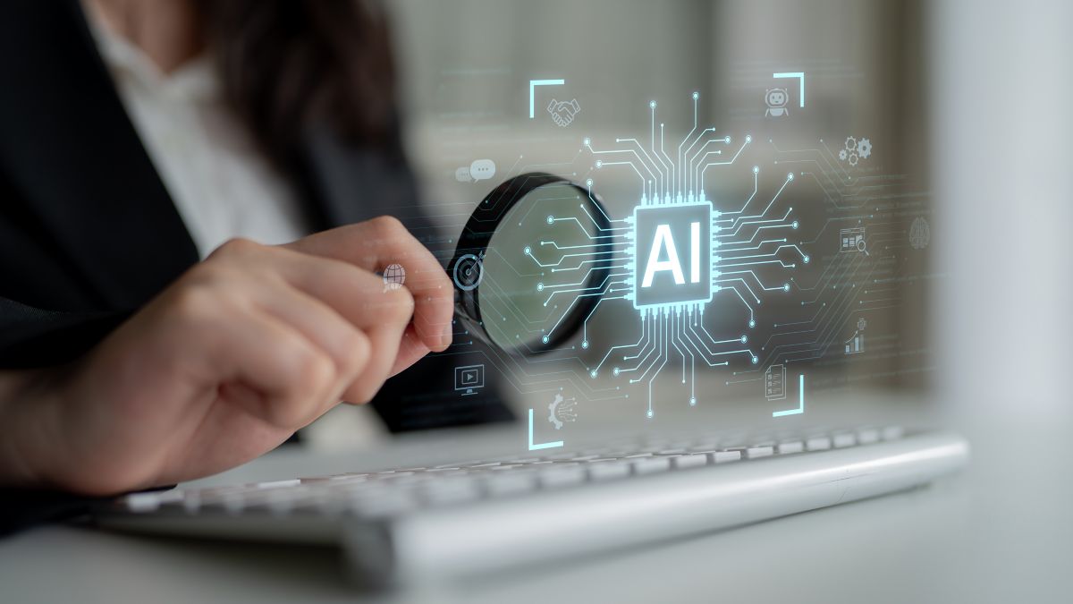 Person using a magnifying glass over an AI chip icon, symbolizing AI-ready technology built on a modernized Salesforce platform.