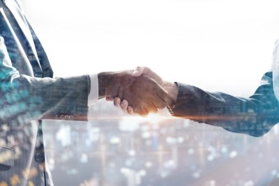 handshake of business people with skyscrapers background and finance and marketing business conclusion