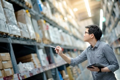 Man checking inventory in warehouse - SAP + Databricks: Putting data and AI to work | DXC Technology Insights 