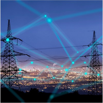 Two electricity pylons over a city at night with mountains in the distance, Energy, Utilities, Oil & Gas | DXC Technology
