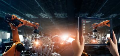 person operating robotic arm via tablet, manufacturing | DXC Technology customer story
