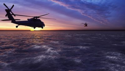 Helicopter hovering over clouds helps secure the mission, as do defense IT modernization services | DXC Technology 