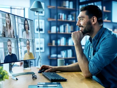 male having a conference call on his computer