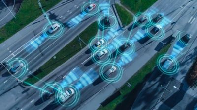 Aerial view of digitally connected cars on elevated highway at night, software-defined vehicles| DXC Technology