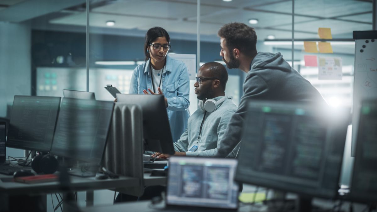 Business professionals discussing ctrm system integration solutions | DXC Technology