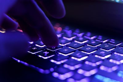 Working on a neon computer keyboard, smart security strategy and foundation | DXC Technology