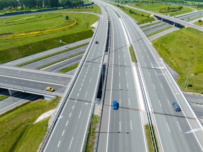 Highway aerial view, overpass and bridge from above, representing Automatic Number Plate Recognition | DXC