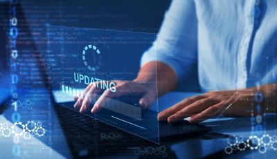 Person using laptop with update screen overlay, symbolizing enhanced security and access control, Zero trust solutions | DXC Technology