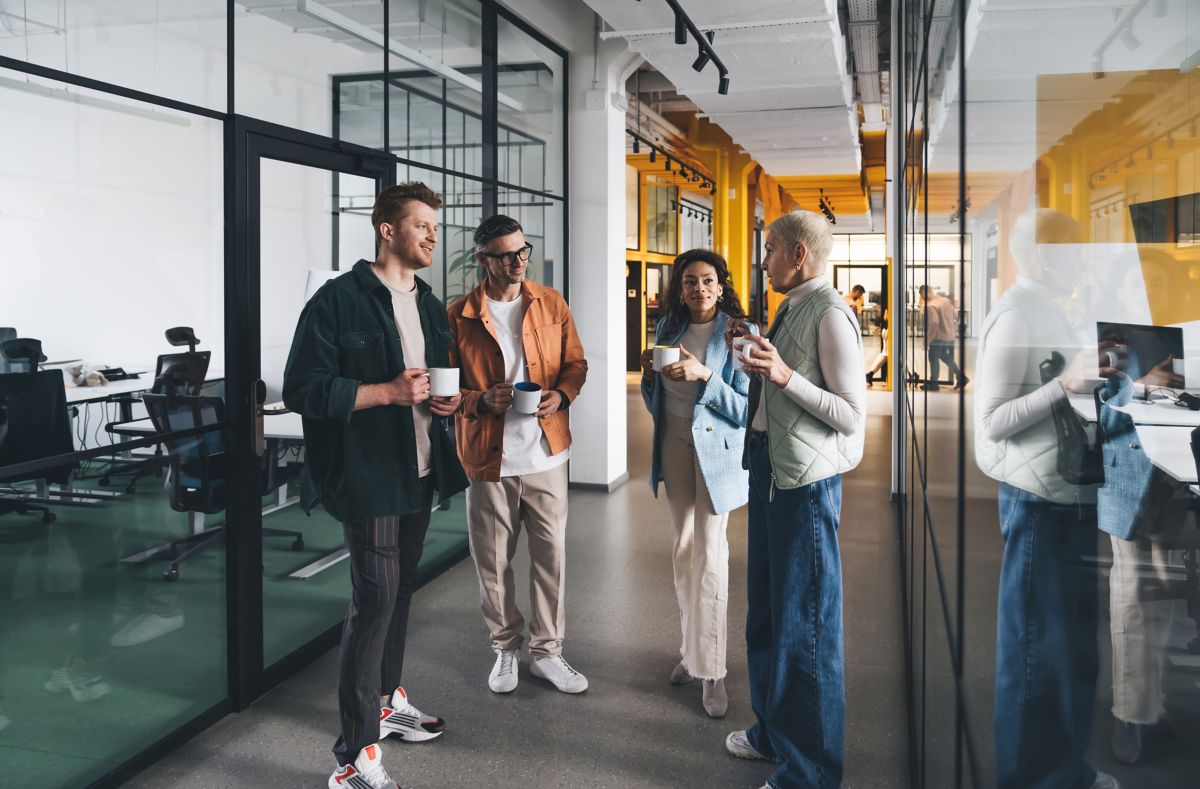 Team of colleagues collaborating in the office, reflecting a long-term Databricks consulting partner relationship | DXC Technology
