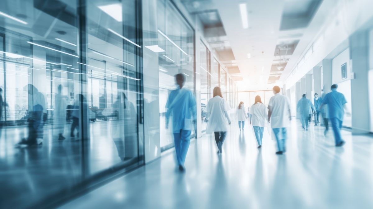 Hospital medical staff walking down wide corridor, Policlinico Umberto Hospital | DXC Technology Customer Stories 