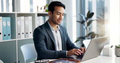Happy, office laptop and professional man, legal advocate or government attorney with career smile, job experience or pride. Corporate portrait, law firm and professional lawyer working on project.