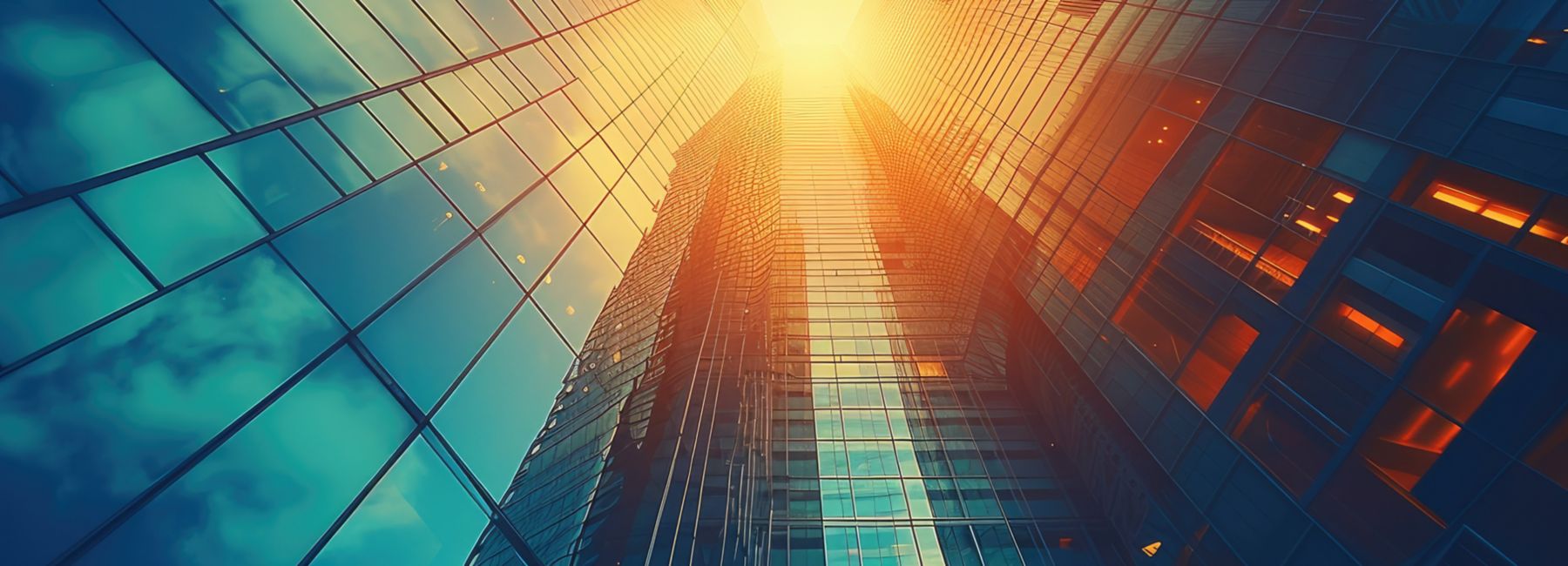 Building with glass windows reflecting clouds, Cloud & Infrastructure | DXC Technology