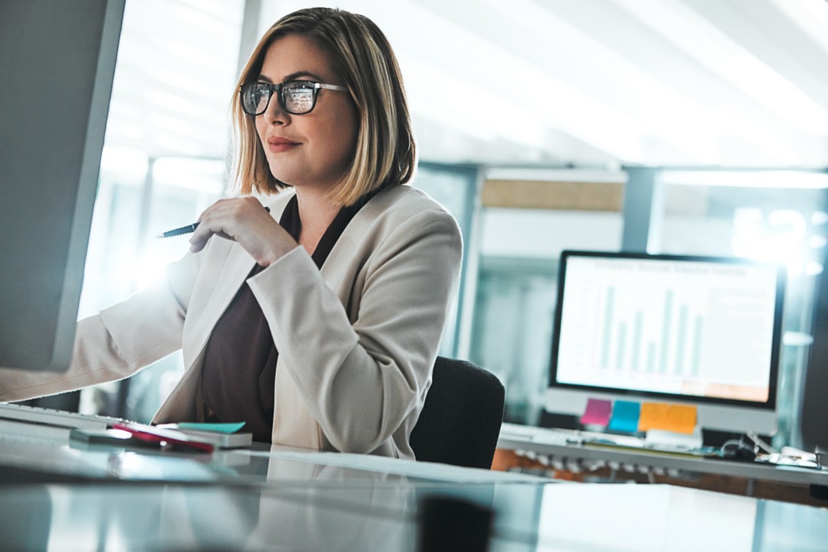 Close-up of a human face blending with digital code, representing Hogan’s API & Microservices solution | DXC Technology Insights