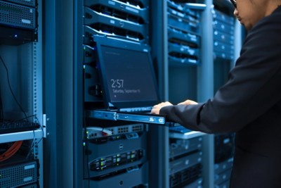 Man fix server network in data center room .