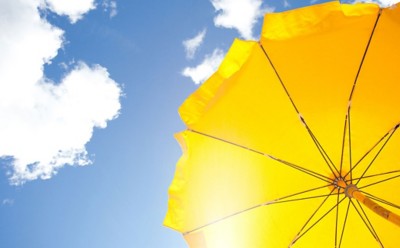 yellow umbrella on blue sky with clouds, yellow umbrella on blue sky with clouds