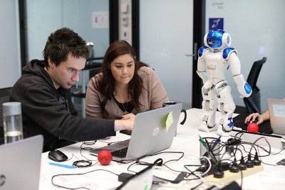 DXC Dandelion Program Co-ordinator, Felicia Vozzo working with Daniel, one of the DXC Dandelion team members (credit: DXC)