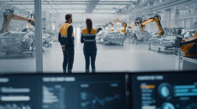 Male and female technicians on factory floor, Enterprise Data & AI Platforms | DXC Technology