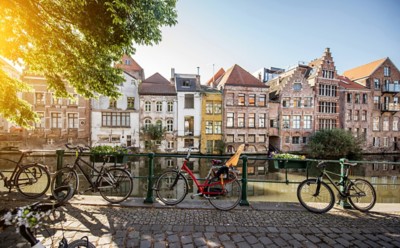 Riverside view with beautiful old buildings and bicycles during the morning light in Gent city, Belgium