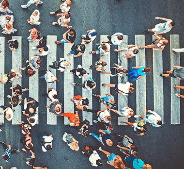 people crossing the road at a crosswalk