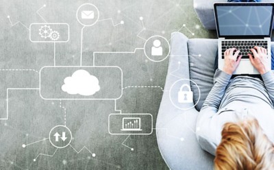 Cloud Computing with man using a laptop in a modern gray chair