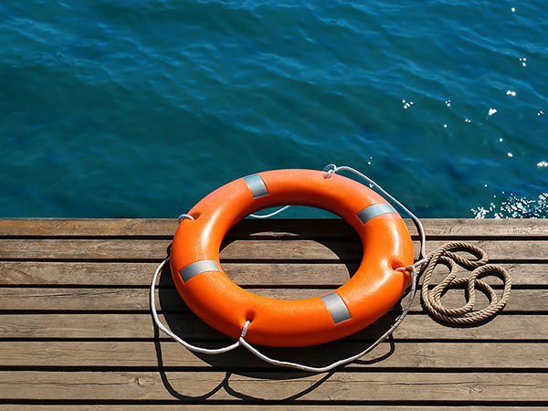 life preserver on a deck by the water