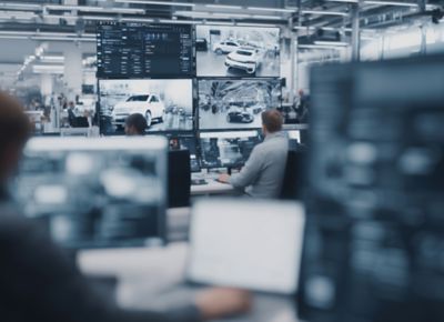 Busy automotive software development office, Software-defined vehicle platform | DXC Technology