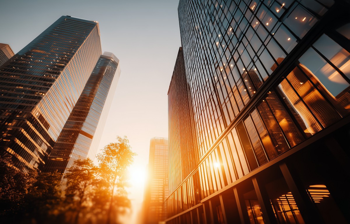 Skyscrapers in a modern cityscape illuminated by warm sunset light showcasing architecture