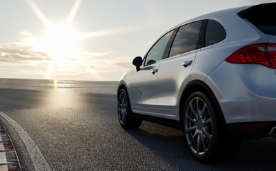 3d car sedan rides on the road to meet the sun