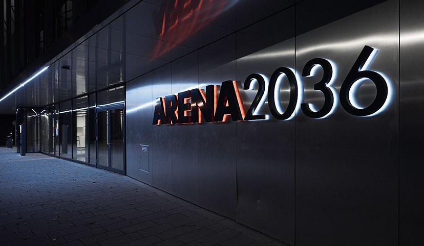 Young engineers meeting with computer code reflected on glass wall, AI & Data | DXC Technology