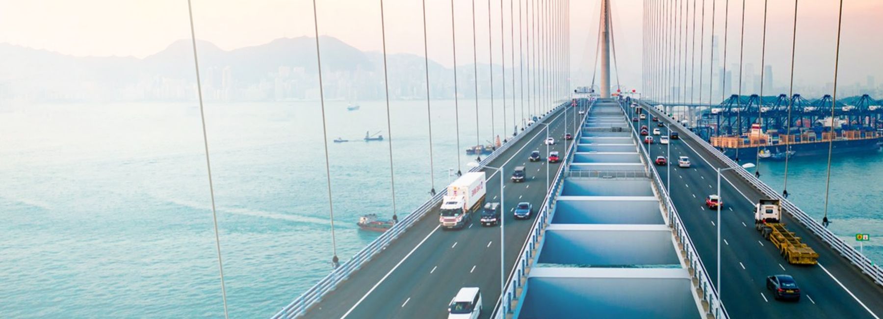 Drone view of Stonecutters Bridge and the Tsing sha highway with traffic in Hong Kong at sunset, Automotive  | DXC Technology