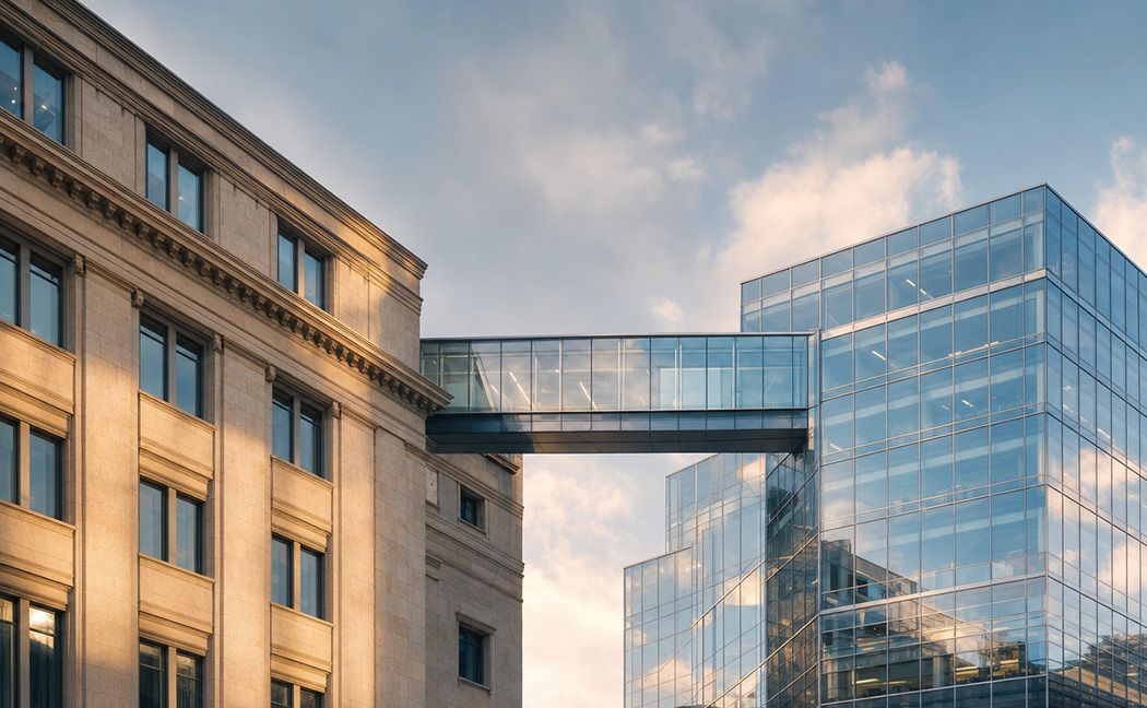 Historic bank building connected by a glass bridge to a modern office, illustrating banking modernization | DXC Technology