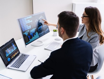 Stock Market Broker Analyzing Graphs On Computer