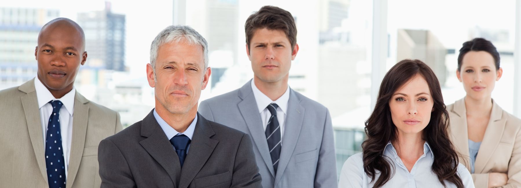 Five employees in business clothes standing together | DXC Technology Insights