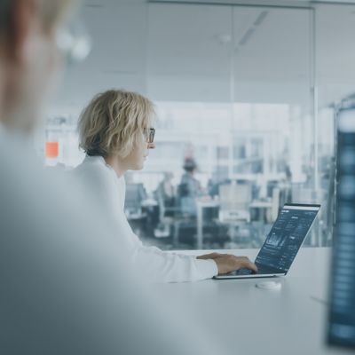 Hand analyzing environmental data with net zero dashboard, Business Process Services, Financial Services | DXC Technology